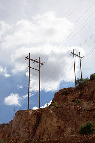 High Voltage Power Lines Against Sky