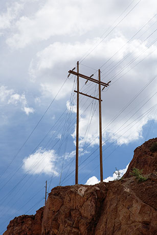 High Voltage Power Lines Against Sky