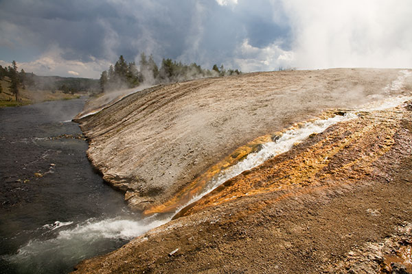 Hot water flowing into Firehole River from Grand Prismatic Spring in Yellowstone National Park